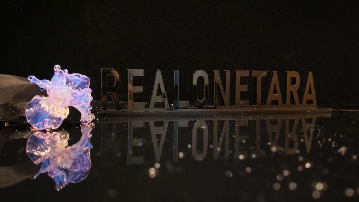 Liuli flower jewelry piece with REALONETARA branding, showcasing the art of hand-poured colored Liuli