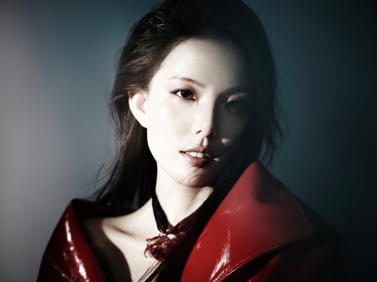 Founder wearing the Magical Red Black Liuli Glass Rose Choker Necklace, styled in a red leather jacket against a blue background