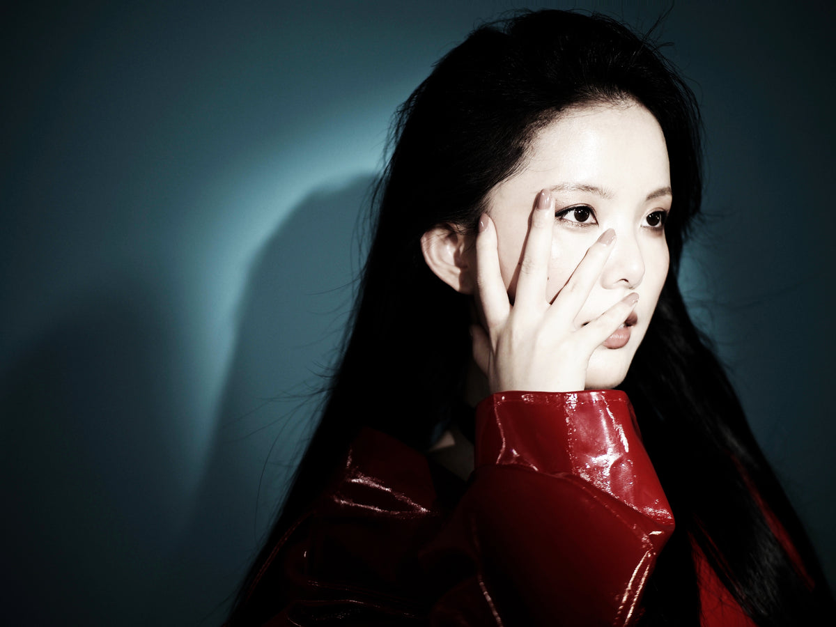 REALONETARA founder in red glossy leather jacket, close-up portrait