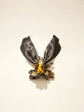 Handcrafted black gold Liuli glass iris choker necklace on white background, black organza ribbon chain with lobster clasp