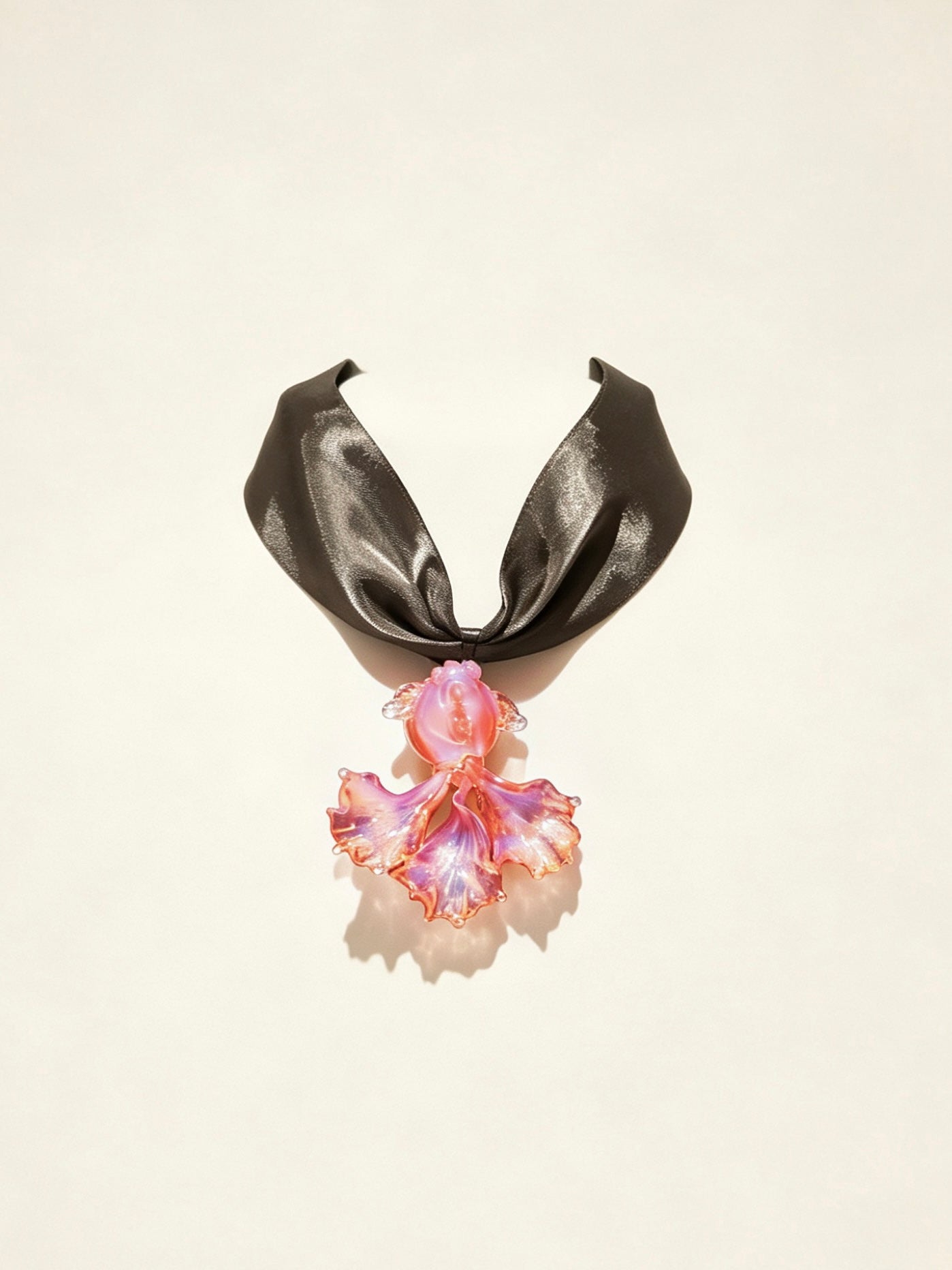 Handcrafted pink Liuli glass koi fish choker necklace on white background, black organza ribbon chain with lobster clasp