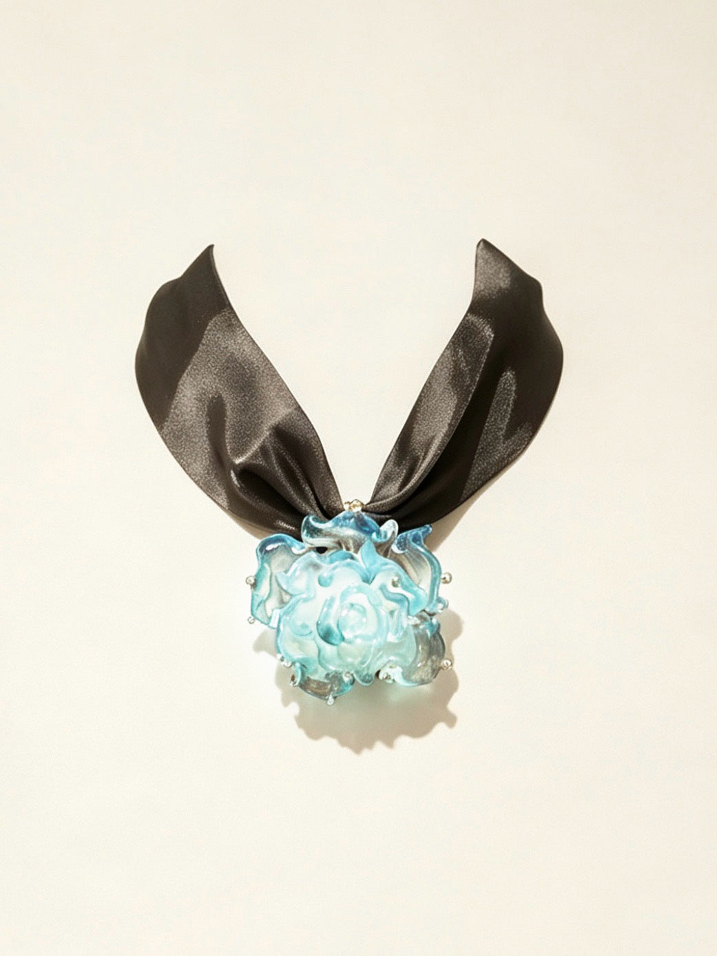 Handcrafted blue Liuli glass rose choker necklace on white background, black organza ribbon chain with lobster clasp