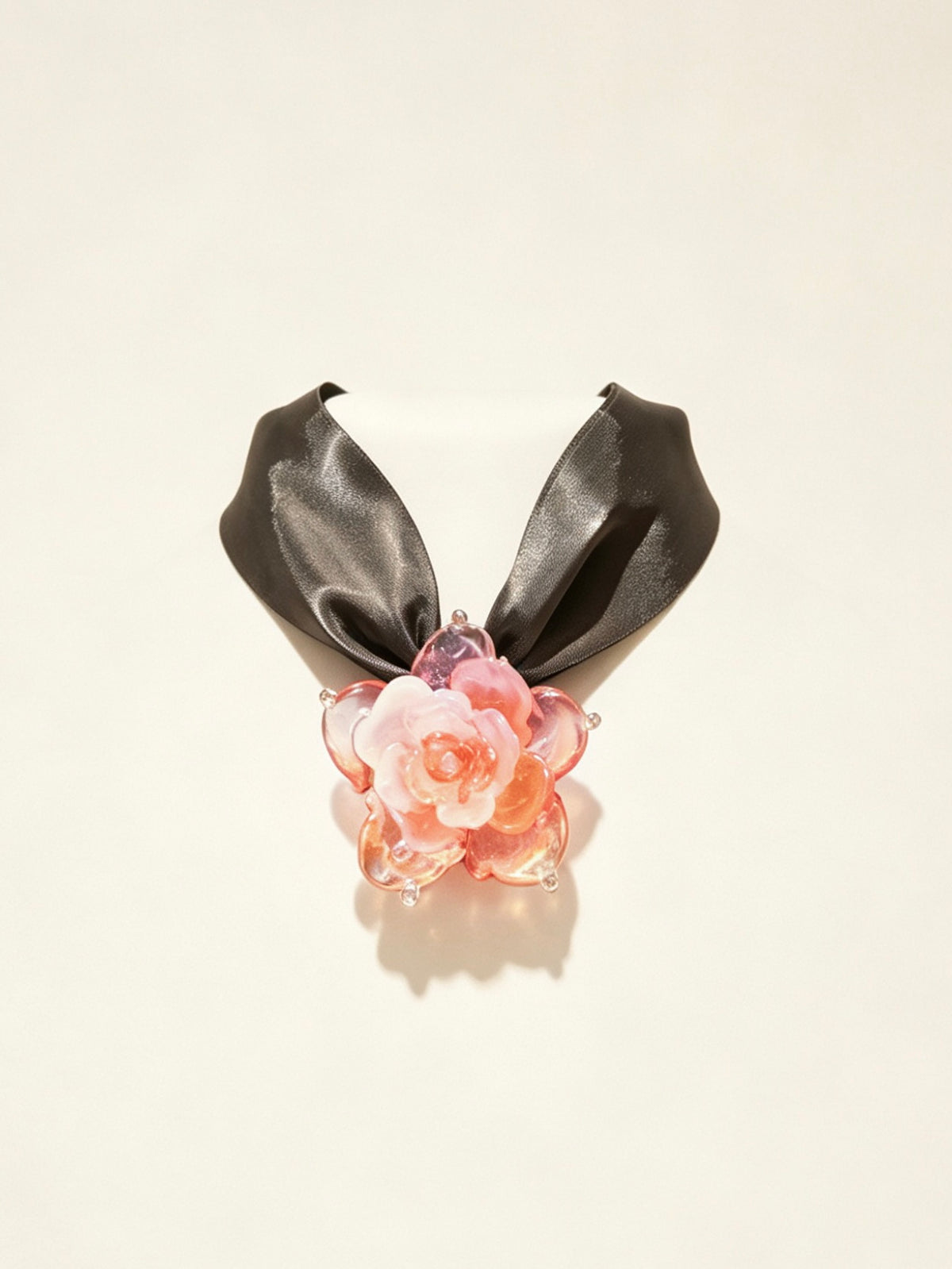 Handcrafted pink gold Liuli glass rose choker necklace on white background, black organza ribbon chain with lobster clasp