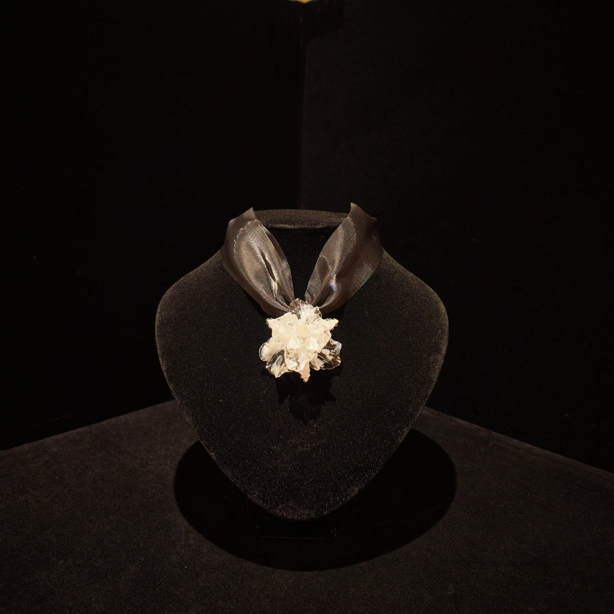 REALONETARA Moonlight White Iris Flower Liuli necklace displayed on a black jewelry bust.