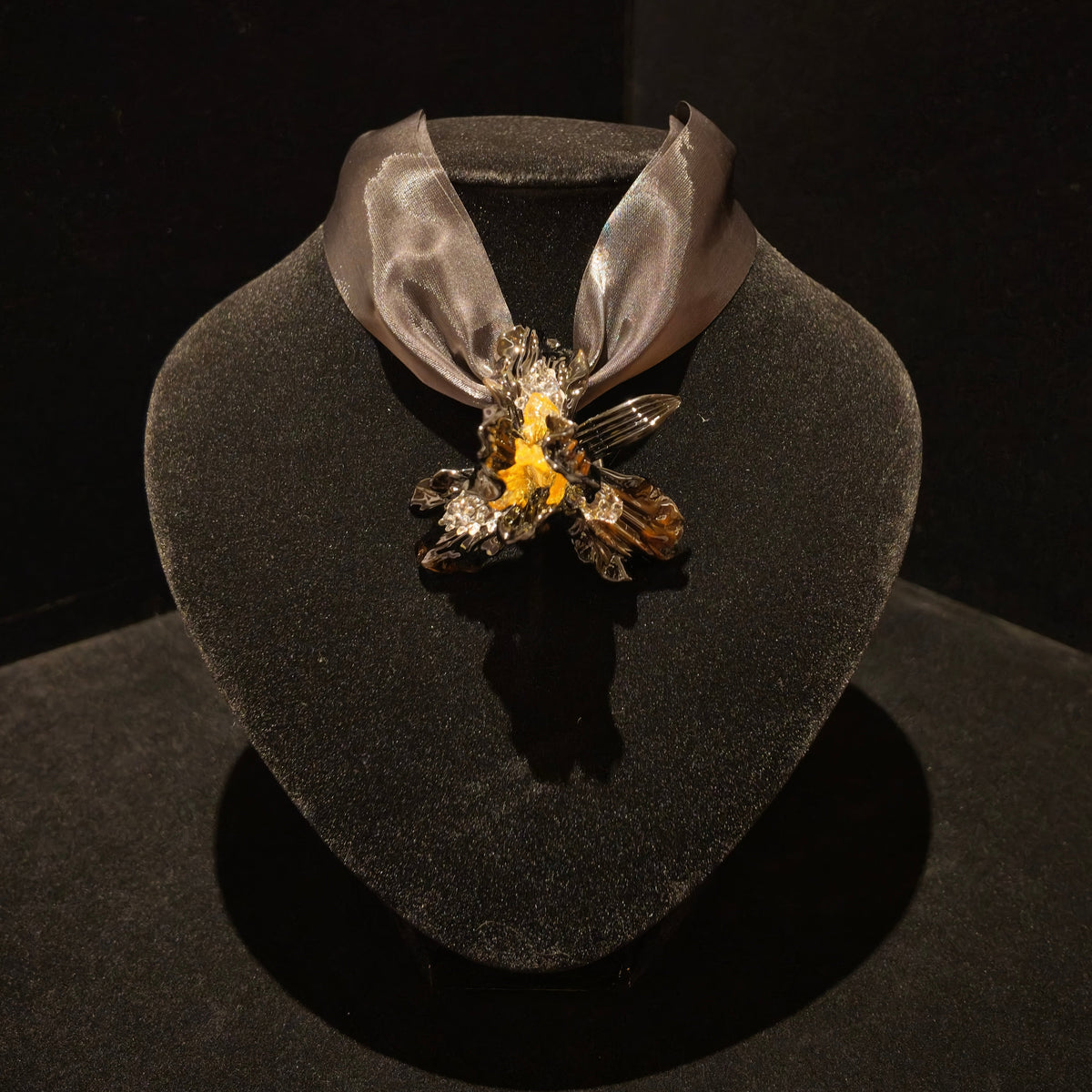 REALONETARA Starfire Liuli flower necklace displayed on a black jewelry bust.